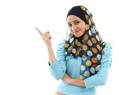 foto of points  - Cute young Muslim woman pointing on empty space - JPG 