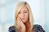 picture of pressure  - Young woman in pain is having toothache - JPG 