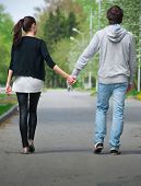 pic of walking  - Young couple walking together hand by hand  in park - JPG 