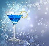 foto of pour  - Blue cocktail being poured into a glass on abstract lights background - JPG 