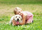picture of animals  - A little blond girl with her pet dog outdooors in park - JPG 