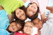 stock photo of laughter  - Group Of Children Looking Down Into Camera - JPG 