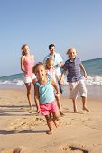 pic of holidays  - Portrait Of Running Family On Beach Holiday - JPG 