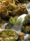 pic of seep  - Flowing springwater seeping through rocks and stones - JPG 