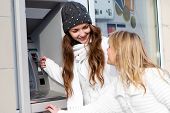 pic of money  - Happy girls withdrawing money from credit card at ATM - JPG 