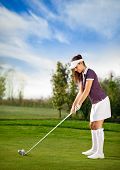picture of golf  - Attractive golfer girl on golf course - JPG 