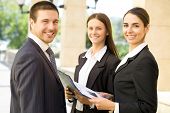pic of leadership  - Young business people talk against a building of modern office - JPG 