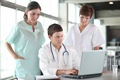 stock photo of medical doctors  - closeup of doctor and nurses in a meeting - JPG 