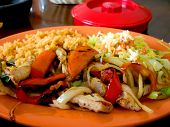 image of restaurant  - Chicken Fajita dinner on plate at a Mexican restaurant in the afternoon sunlight - JPG 